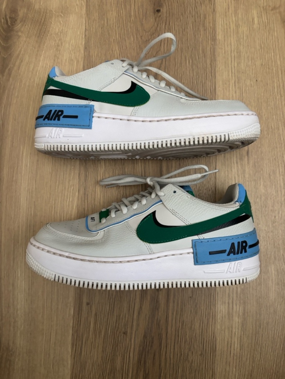 Nike White Sneakers with Green Swoosh and Blue Heel Patch